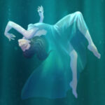 Woman floating underwater in dress.